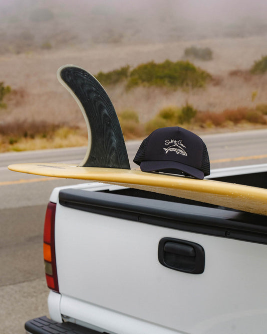 Lifestyle shot of the Catch Of The Day Trucker Hat - Black. 