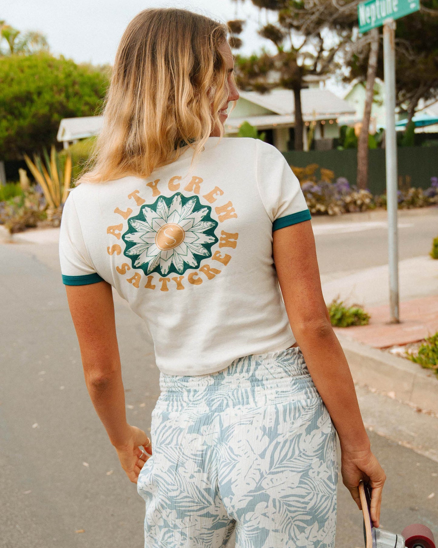 Lifestyle shot of the Flower Power Ringer Tee - Off White/Kelp. 