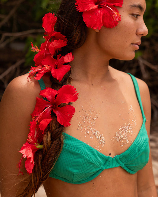 Lifestyle shot of the Seafarer Balcony Bikini Top - Kelly Green. 