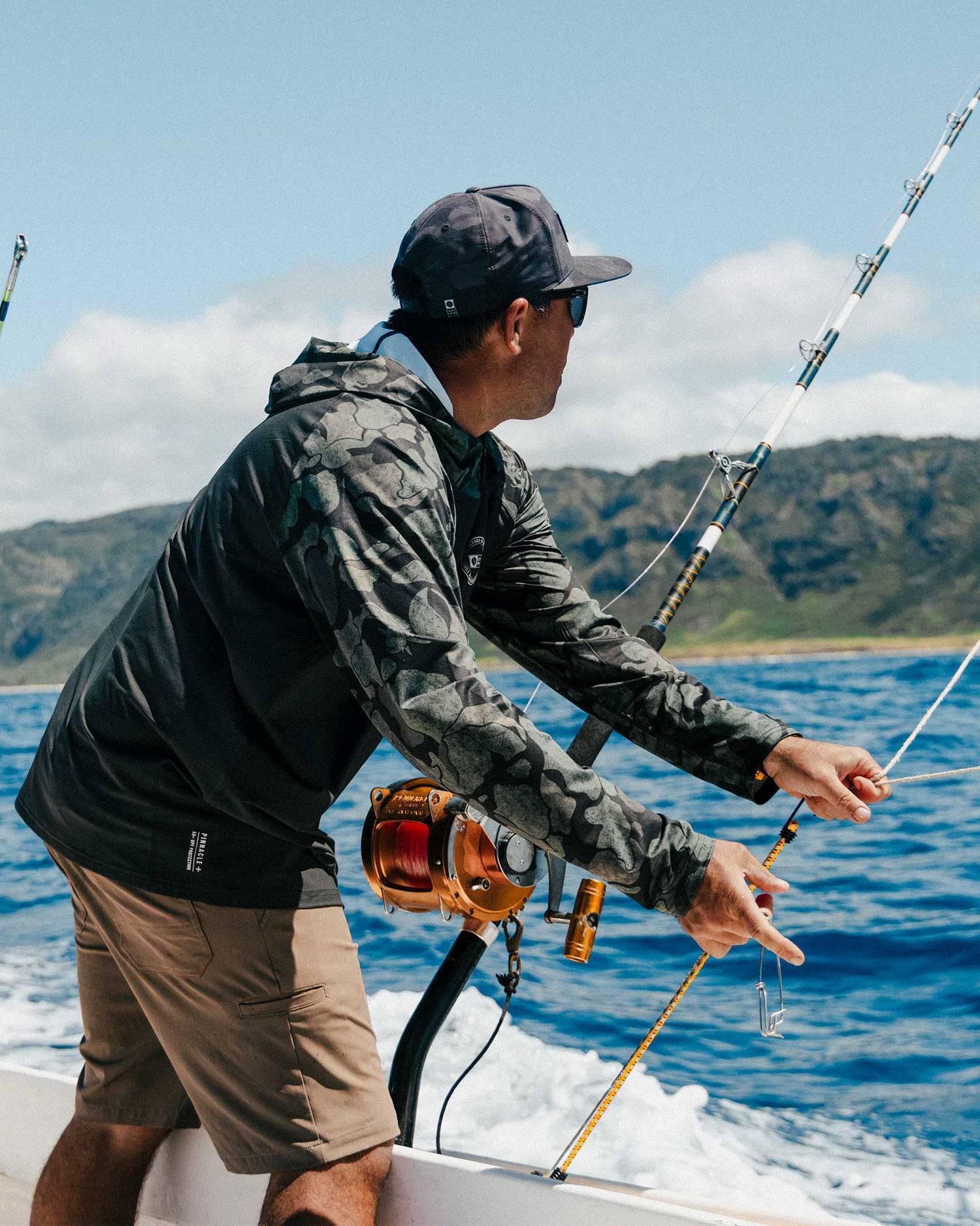 Lifestyle shot of the Apex Perforated Sunshirt Hoodie - Black Camo. 