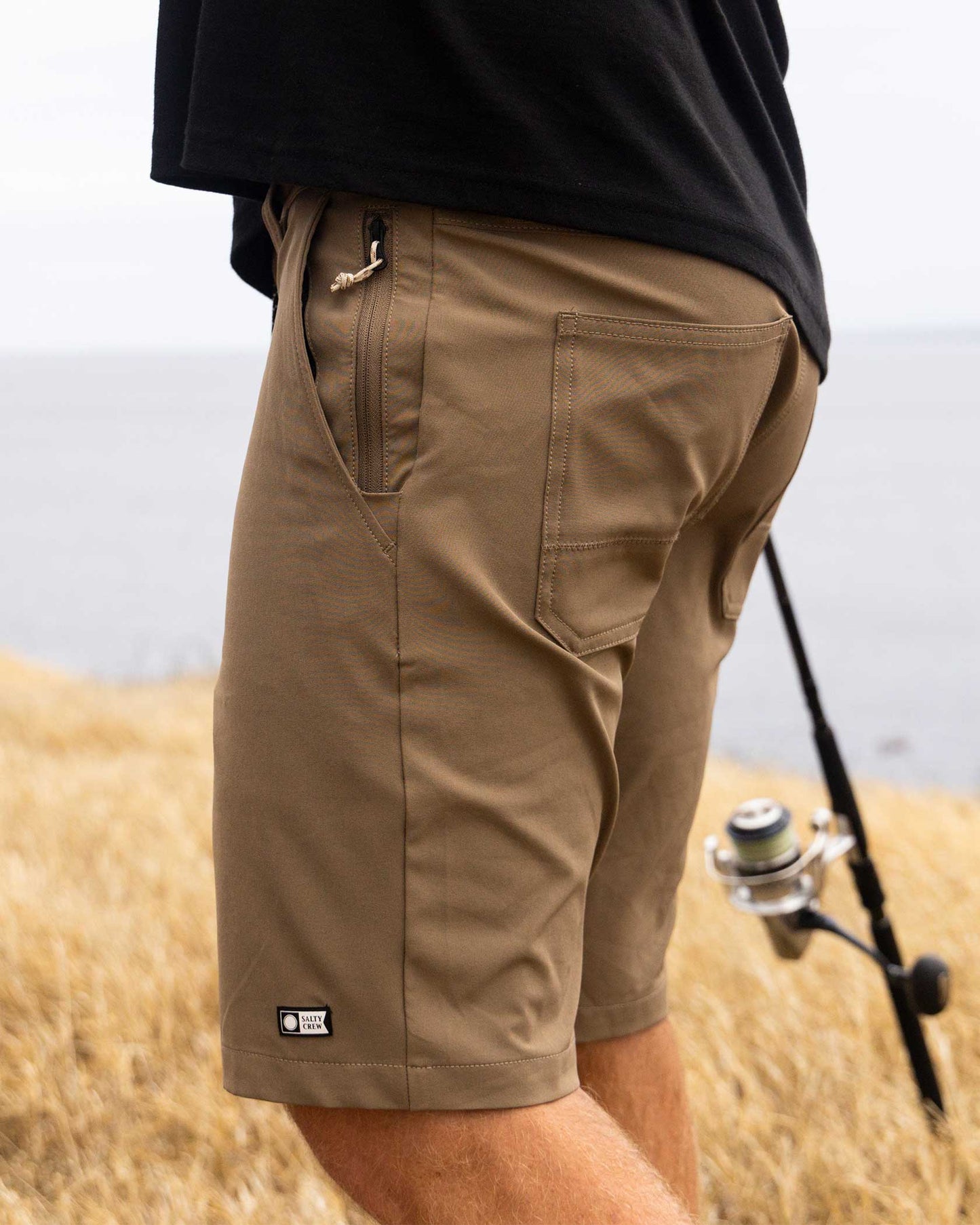 Lifestyle shot of the Midway 19" Utility Short - Earth. 